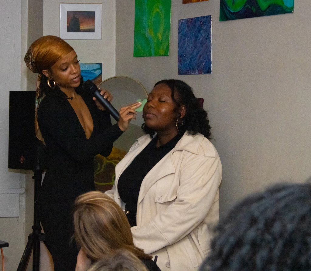 Jade speaking and demoing gua sha at a live event